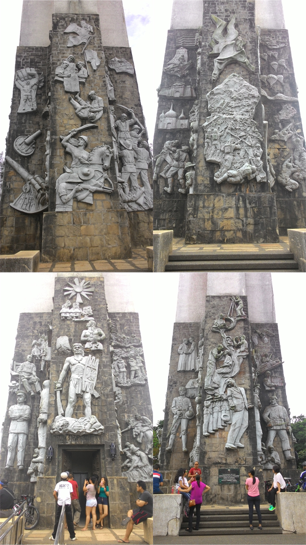 The carvings on the base of the cross.