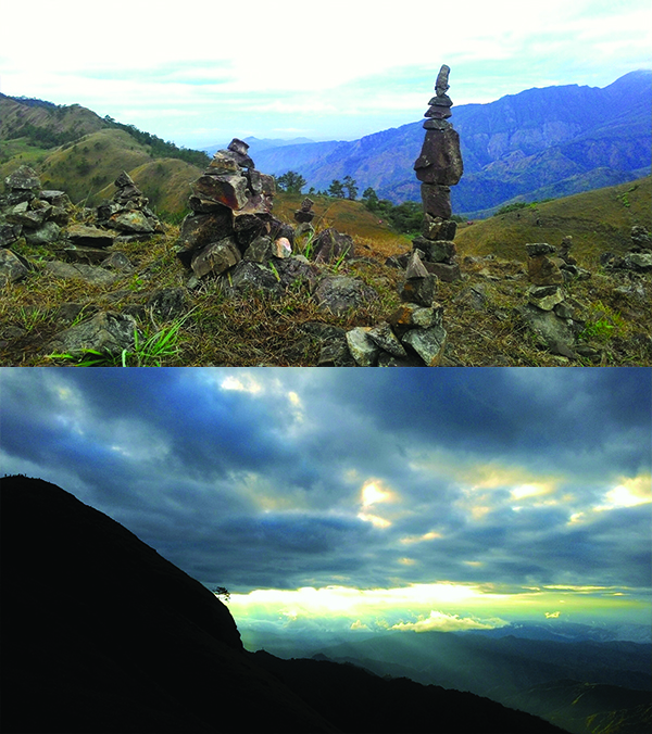 The peak with the balancing rocks and sunlight piercing through the clouds