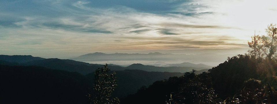 Distant sea of clouds and the sunrise from Indupit village